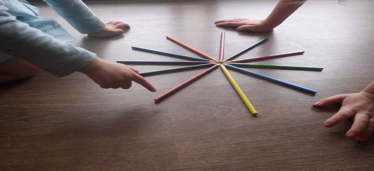 Child Psychotherapy, picture of children playing on the floor, pencil on the floor